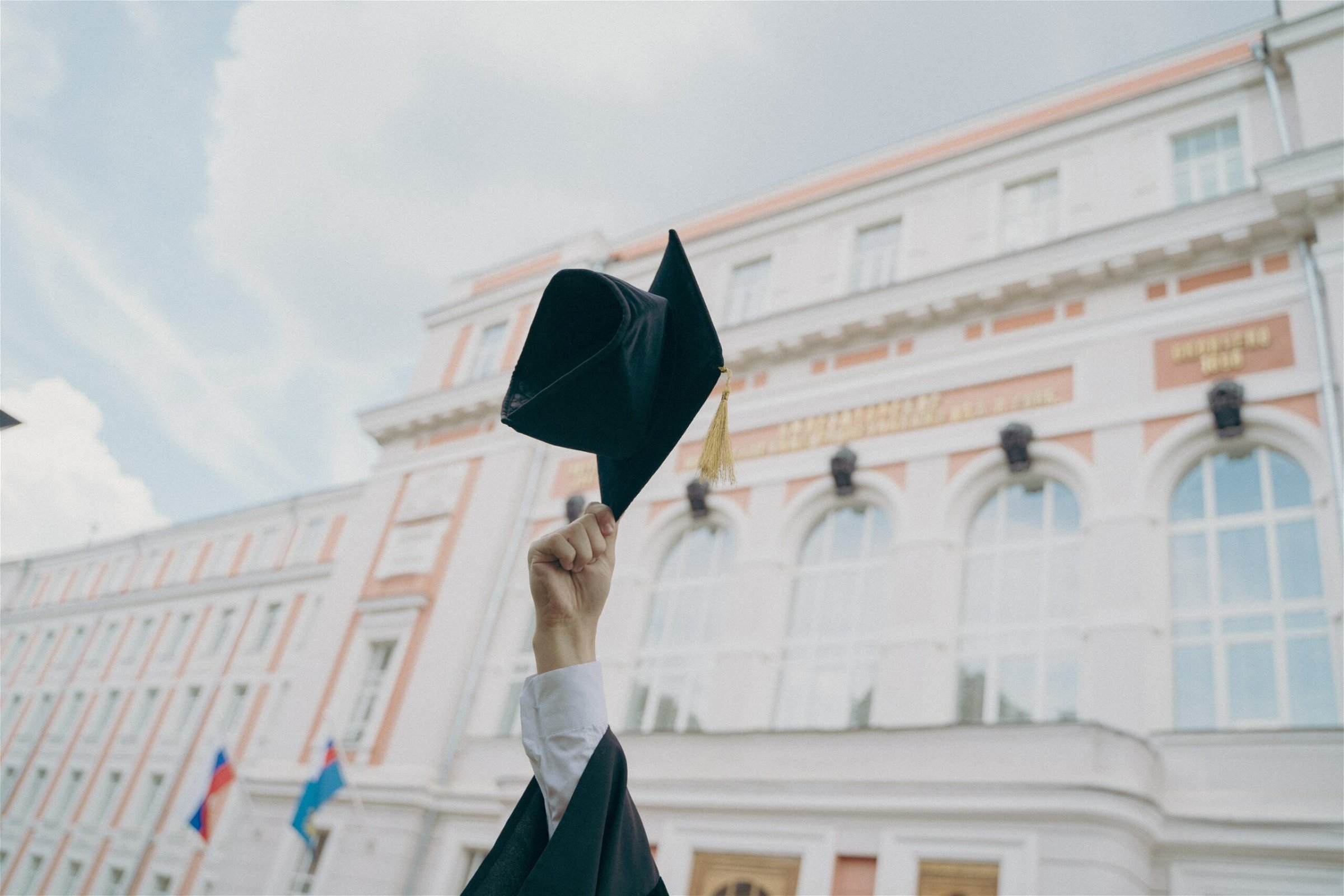 Image of hand holding up a graduation cap - Destination Certification