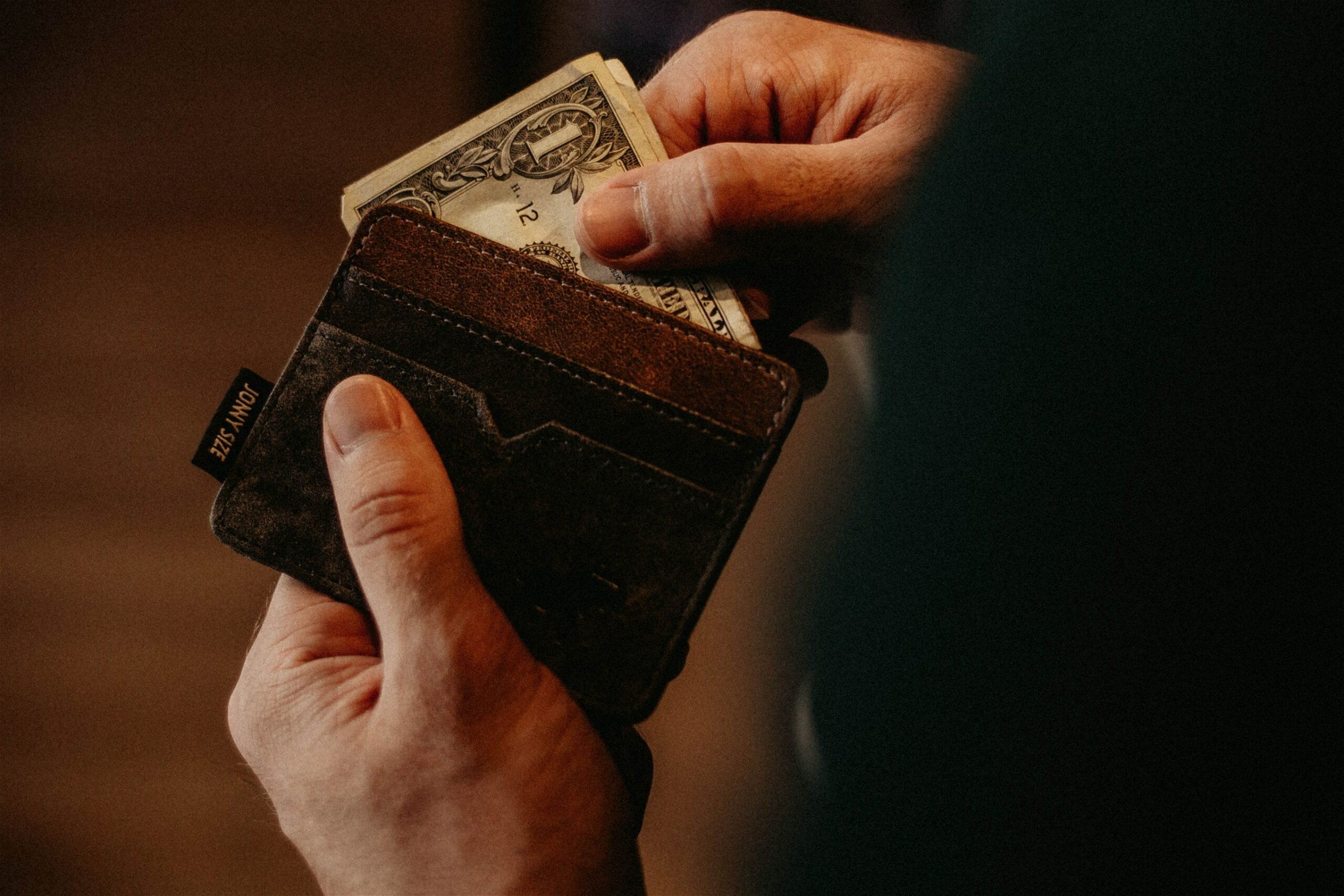 Image of a man holding wallet - Destination Certification