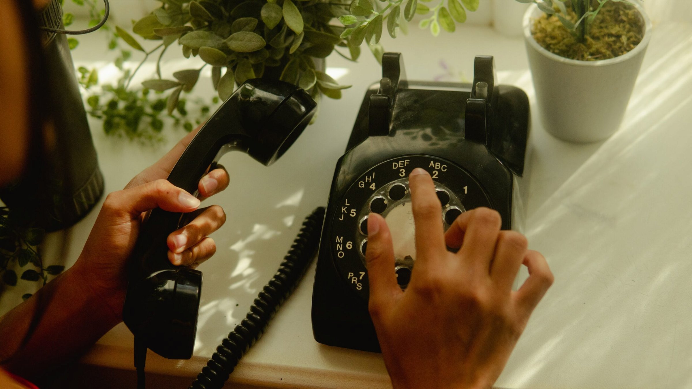 Image of someone dialing a rotary phone - Destination Certification