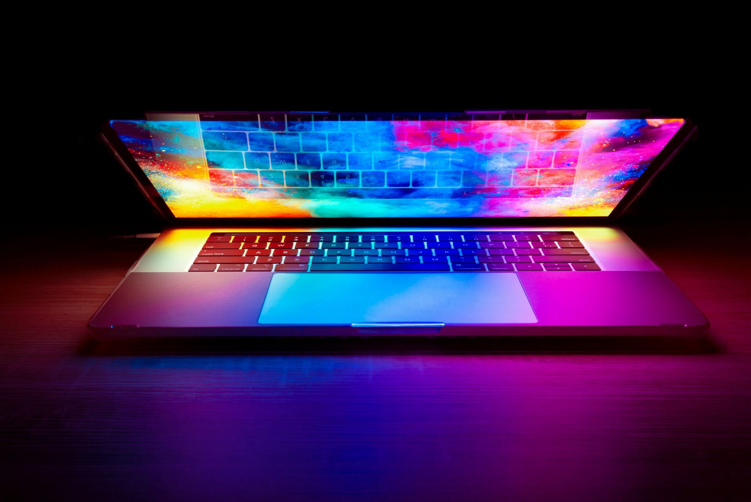 Image of a laptop with rainbow screen saver - Destination Certification